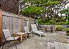 Fully fenced back yard with outdoor dining seating and lounge chairs 