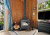 Living room with woodstove, streaming TV, DVD player. 