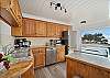 Well stocked kitchen with amamzing ocean views with bar seating. 