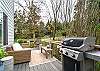 Hot tub on the back deck, with outdoor dining, lounge furniture, Gas BBQ, and fenced in area. 