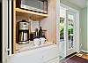 Fully equipped kitchen, and dining area. Door out to the back yard area. 