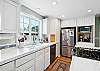 Fully equipped kitchen, and dining area. Door out to the back yard area. 