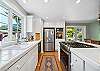 Fully equipped kitchen, and dining area. Door out to the back yard area. 