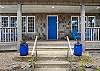 Front covered porch with Adirondack chairs for relaxing in. 