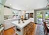 Fully equipped kitchen, and dining area. Door out to the back yard area. 