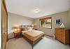 Upstairs queen bedroom with distant ocean view