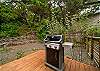 Back yard deck with outdoor dining table, Gas BBQ, lounging chairs. 