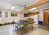 Garage with Ping pong, beach toys, beach chairs, extra fridge, washing sink