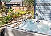 Back yard area with hot tub and outdoor firepit. 
