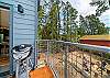 Upper deck that overlooks the back yard with breakfast table, electric BBQ.