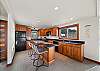 Gourmet Kitchen with breakfast bar open to living area, dining area, and with ocean views