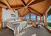 Master bedroom with expansive views, working desk and lounge chair. 