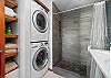 Downstairs full bath with walk in shower with stackable washer/dryer