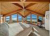 Master bedroom with expansive views, working desk and lounge chair. 