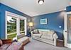Den with golf course view, desk workspace, Queen sofa sleeper, and lounge chair. 