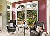 Living room with Smart TV, Wood burning fireplace, and golf course view.