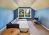 Upstairs bedroom with Euro double sleeper, DVD TV, wet bar, mini fridge, golf course view, and peak ocean view. 
