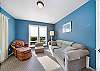 Den with golf course view, desk workspace, Queen sofa sleeper, and lounge chair. 