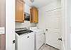 Hall laundry room with Access to garage. 