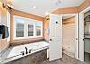 Master bath with jacuzzi tub, walk in shower, large walk in closet and double sinks. 