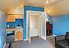Upstairs bedroom with Euro double sleeper, DVD TV, wet bar, mini fridge, golf course view, and peak ocean view. 
