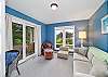 Den with golf course view, desk workspace, Queen sofa sleeper, and lounge chair. 