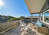 Deck with outdoor lounging furniture and ocean view