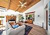 Living room with streaming TV, open to dining area. Woodstove is NOT operational