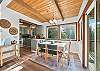 Dining area with access to deck with BBQ and outdoor seating. 