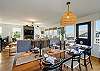 Large dining table open to Living area with streaming TV, ocean view, access to the deck with outdoor dining table.