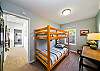 3rd lower bedroom with a set of bunk beds and office desk. Access to garage through this room. 