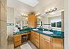 Large master bath with double sinks and vanity area.