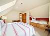 Upstairs King bedroom with twin bed, desk, and private deck. 