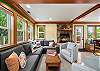 Living room with wood fireplace open to kitchen and dining area. Streaming TV and cable. 