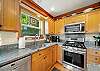 Fully equipped kitchen with gas stove, large fridge and drip pot and pod coffee maker. 