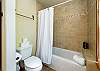 Tub and shower combination in the downstairs full bathroom.