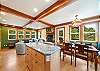 Dining area with bench seating. Fully equipped kitchen, access to outside deck and hot tub. 