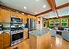 Fully equipped kitchen with gas stove and island. Open to living space and dining room. 