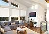 Living room with streaming TV, ocean view, and comfortable seating. 