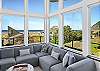 large picture windows in living room with ocean views