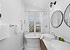 Soaker tub with ocean view and shower combination, with double sinks in the master bath.