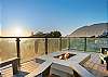 Outdoor fire table with ocean and mountain views.