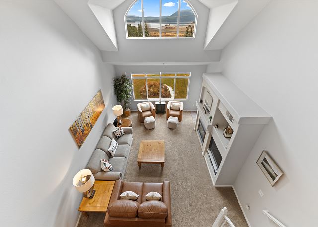 Spacious living area with flat screen TV, gas fireplace, ample seating, and vaulted ceilings.