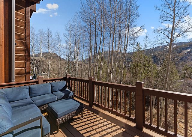 Private balcony with outdoor seating and slope views. 