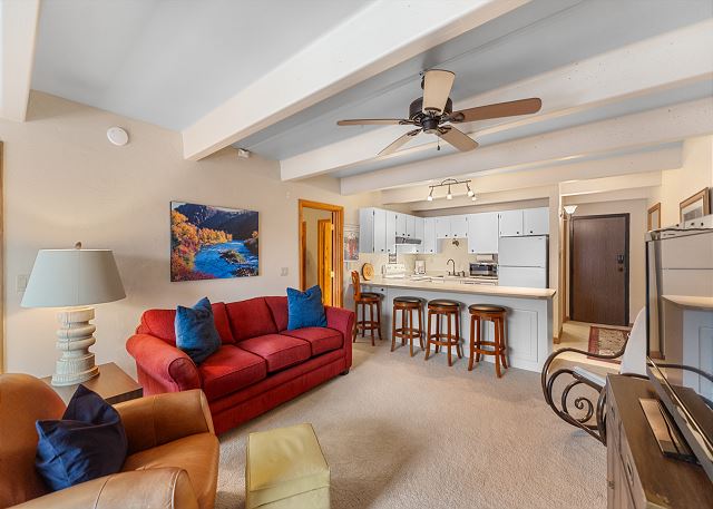 Living area featuring a fireplace, TV, queen sleeper sofa, and balcony access. 