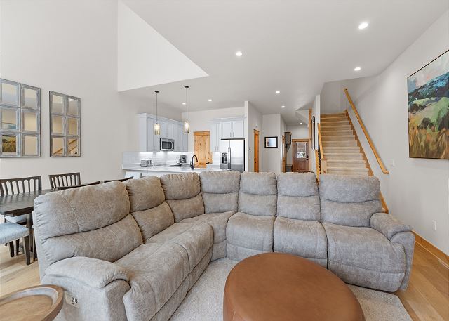 The living area features a mounted TV over a cozy fireplace.