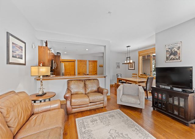 The living area offers a TV, stone surround fireplace, and queen sleeper sofa. 