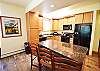Kitchen with Granite Counters and Bar Seating for 3