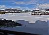 Deck View of the Frozen Lake and Mountains