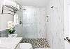 This stunning bathroom features a walk-in rainfall shower, as relaxing as it is beautiful.